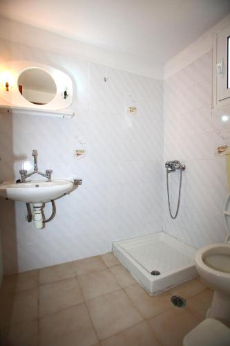 a bathroom with a sink and a shower and a toilet at Karidies in Skopelos Town