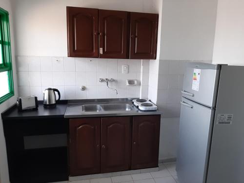 a kitchen with a sink and a refrigerator at TODO EL CENTRO A TUS PIES in Formosa