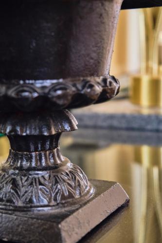 a metal vase sitting on top of a table at Casa Rubinacci in Naples