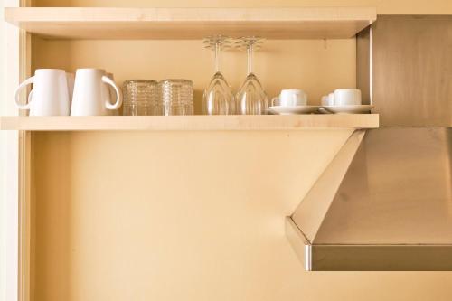 a shelf with glasses and other items on it at Casa Rubinacci in Naples