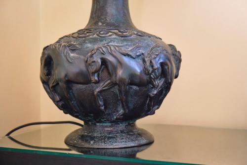 a black vase with a horse on it on a table at Casa Rubinacci in Naples