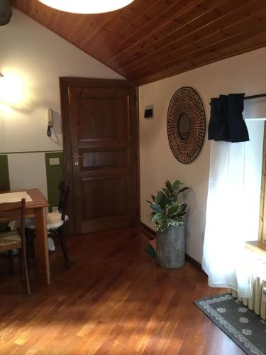 a living room with a wooden floor and a wooden door at La Locandiera in Carona