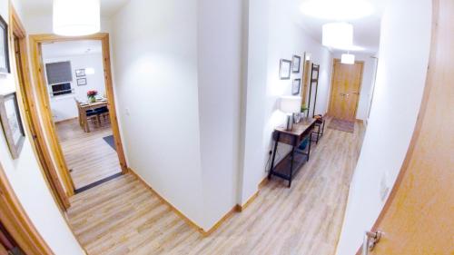 a hallway with a mirror and a dining room at Inverness City Centre Apartment with Elevator and Google Chromecast in Inverness