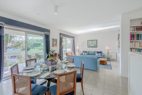 a dining room and living room with a table and chairs at Estoril House in Estoril