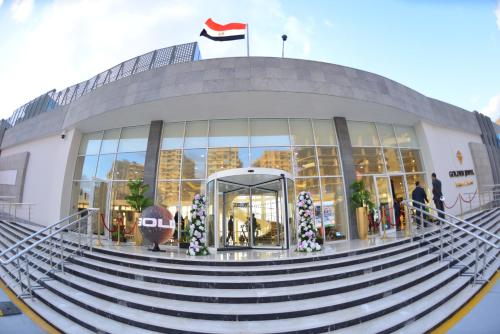 a large building with stairs in front of it at Golden Jewel Beach&Hotel in Alexandria