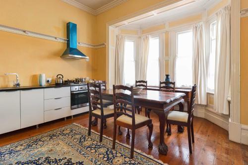 a kitchen with a dining room table and chairs at Fernando's self catering cottages in Port Elizabeth