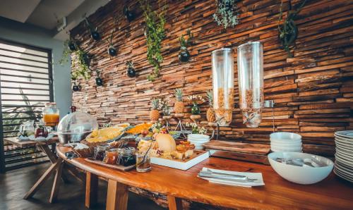 a table with a buffet of food on it at Hotel Chalets Chamarel in Chamarel