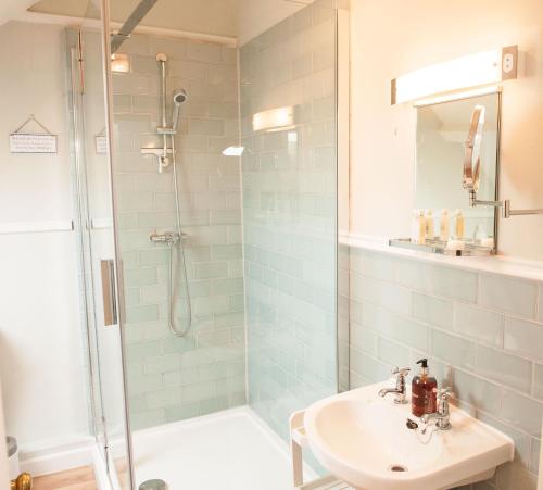 a bathroom with a shower and a sink at Lavender Cottage in Lyme Regis
