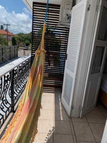 a porch with a hammock on a balcony at Recanto da Sol in Florianópolis