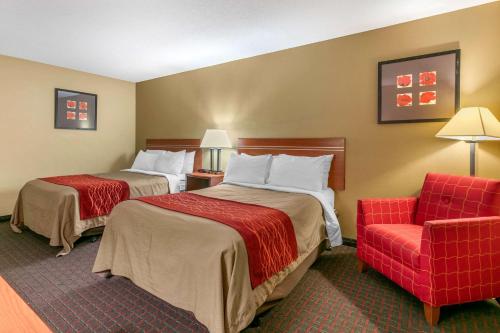 A bed or beds in a room at Rodeway Inn Rapid City