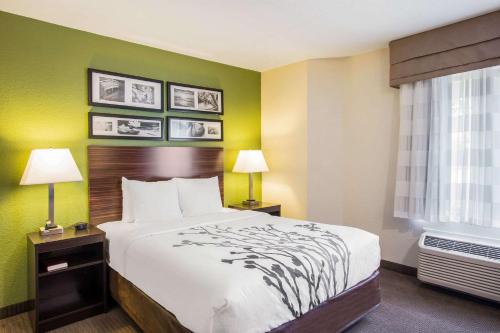a hotel room with a bed and a window at Quality Inn Kansas City International Airport in Kansas City