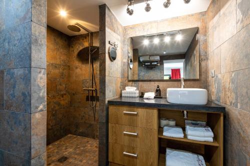 a bathroom with a sink and a shower at THE ADDRESS CASSIS in Cassis