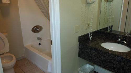 a bathroom with a sink and a toilet at Regency Inn in Moreno Valley