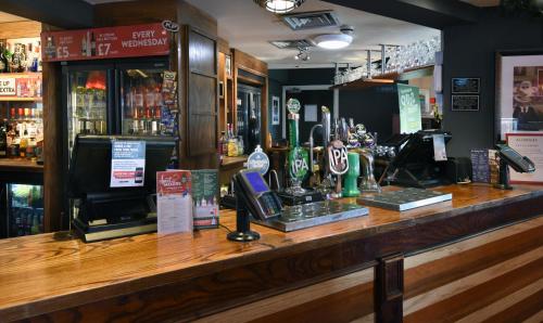 a bar with a telephone and a counter at Lea Gate by Greene King Inns in Preston