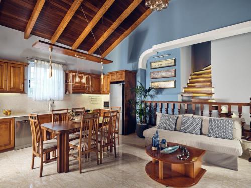 a kitchen and living room with a couch and a table at Villa Castelletto heated pool jacuzzi in Kipseli