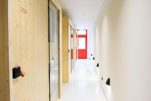 a hallway of a building with wooden walls at The Green Elephant Hostel & Spa in Maastricht
