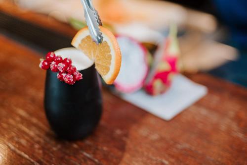 a drink sitting on a table with an orange slice at Hotel Villa Medici in Bad Schonborn