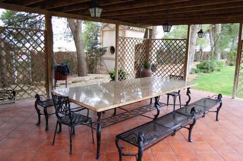 a table and four chairs on a patio at Hotel El Cortijo de Daimiel in Daimiel