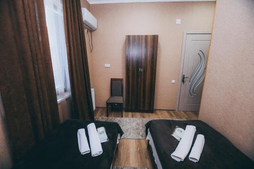 ein Hotelzimmer mit 2 Betten und einer Tür in der Unterkunft kutaisi Sunrise in Kutaissi