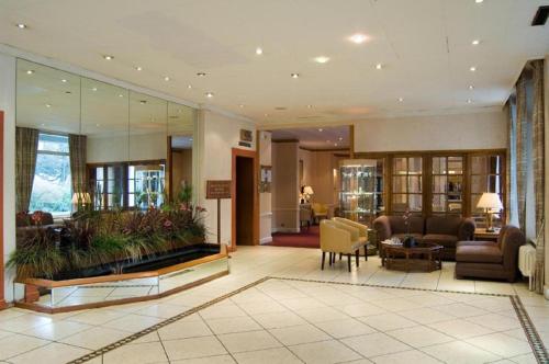 a large living room with a couch and a table at Heathlands Hotel in Bournemouth