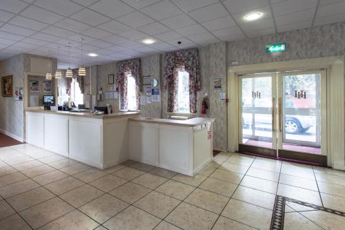 
a kitchen with a sink and a counter top at Heathlands Hotel in Bournemouth
