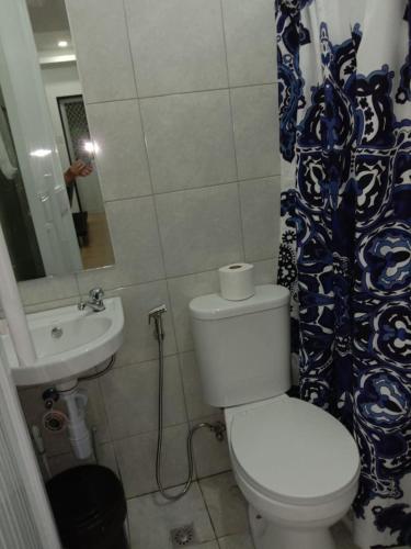 a small bathroom with a toilet and a sink at 2BR townhouses good for 12pax each & NETFLIX & 100Mbps WIFI & pool resort 2min walk & 3km outside Pico de Loro Cove & Calayo Cove - with Endorsement for Pico de Loro Cove good for 7 days & Boat-Tour & Island Hopping assistance in Nasugbu