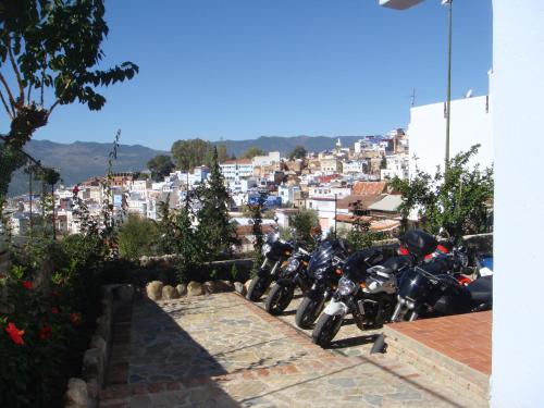 a group of motorcycles parked in front of a city at Hotel Alkhalifa in Chefchaouene