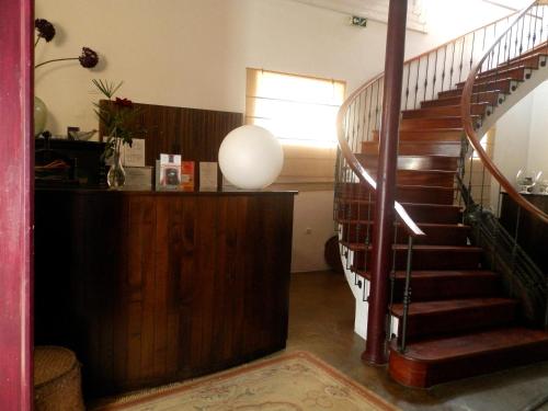a hallway with a spiral staircase in a house at Antiga Moagem in Vimieiro