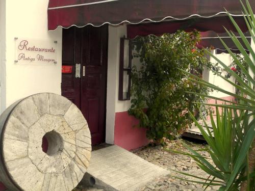 a door to a building with a sign on it at Antiga Moagem in Vimieiro