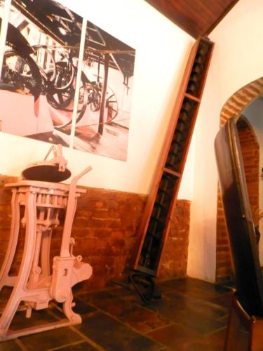 a room with a bike hanging on the wall at Antiga Moagem in Vimieiro