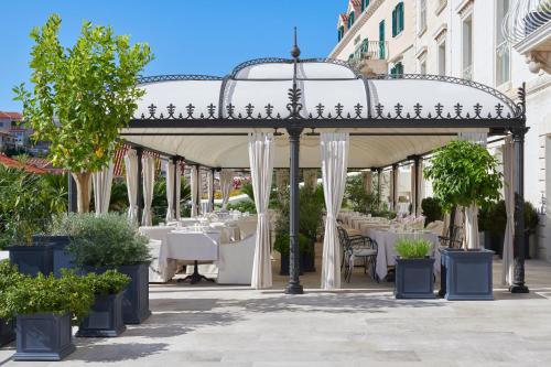 a gazebo with tables and chairs in a restaurant at Palace Elisabeth Hvar Hotel - The Leading Hotels of the World in Hvar