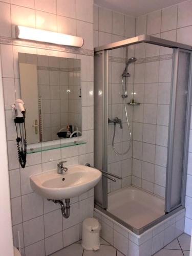 a bathroom with a shower and a sink and a shower at Apartment Lina mit Balkon in Zempin