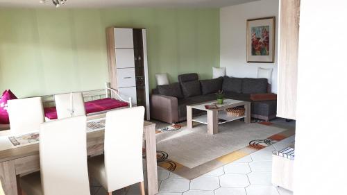a living room with a couch and a table at Ferienwohnung Grüne Oase in Halle an der Saale
