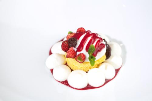 a dessert with berries and whipped cream and marshmallows at Alba Palace Hotel in Favara