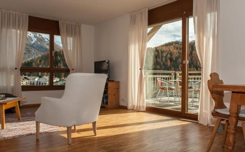 a living room with a view of a mountain at Chesa Guardamunt in Celerina