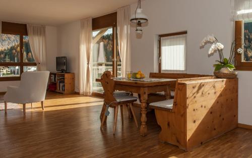 a living room with a wooden table and chairs at Chesa Guardamunt in Celerina
