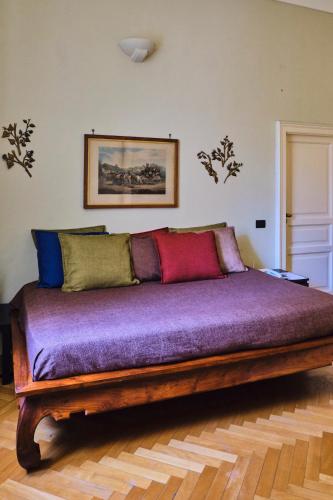 a bedroom with a wooden bed with purple sheets at Casa Rubinacci in Naples