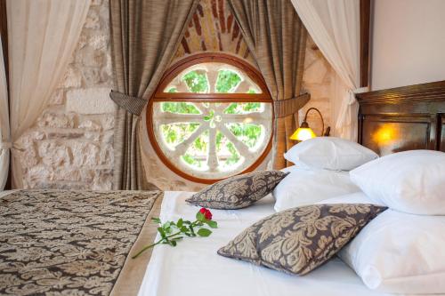 a bedroom with a large bed and a large window at Heritage Boutique Hotel Adriatic-Adults only in Orebić