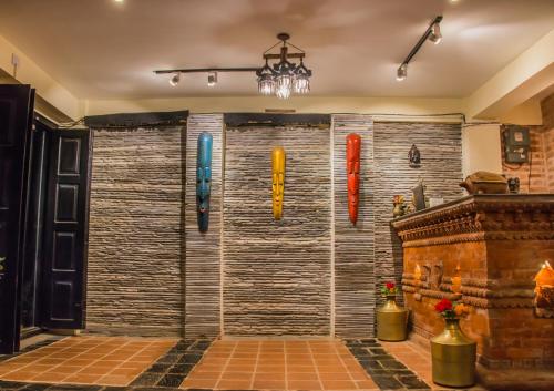 a shower in a room with a large wall with surfboards at HOTEL LAYAKU DURBAR in Bhaktapur