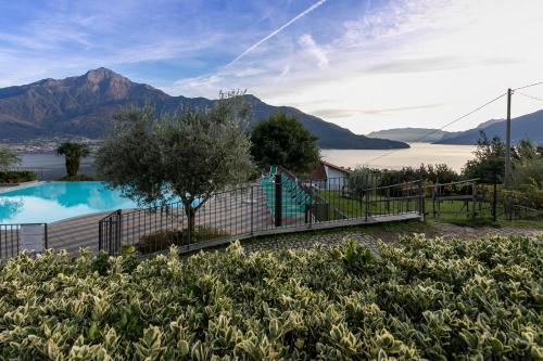 a swimming pool with mountains in the background at La Collina dei Fiori in Vercana
