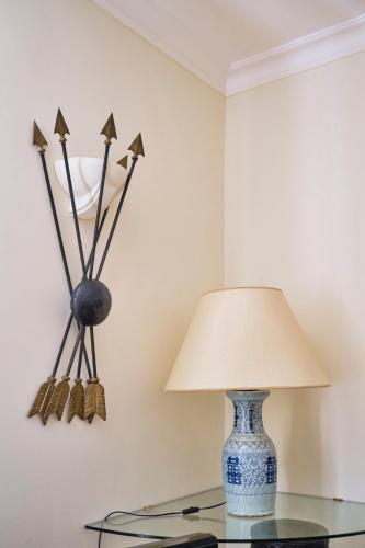 a lamp on a glass table next to a wall at Casa Rubinacci in Naples