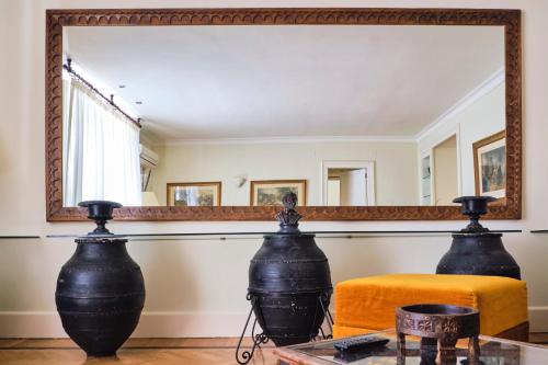 a mirror in a room with a couch and a table at Casa Rubinacci in Naples