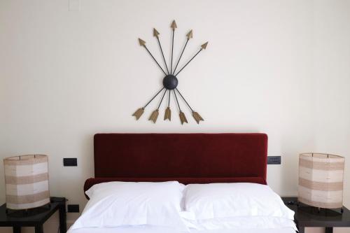 a clock on the wall above a bed at Casa Rubinacci in Naples