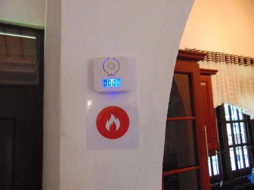 a clock on a wall with some signs on it at SRI LANKAN VILLA in Galle
