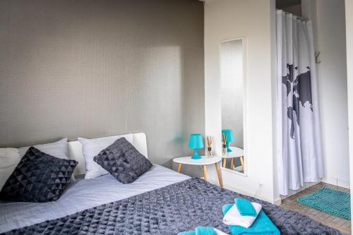 a bedroom with a bed with blue pillows and a window at B&B 1 uit de 100 in Ghent
