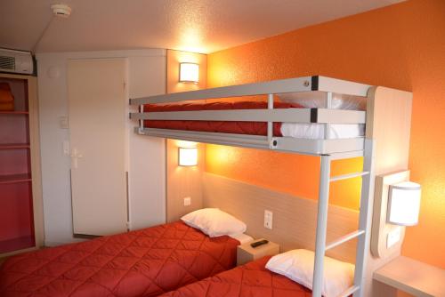 a bedroom with a bunk bed with a red bedspread at Premiere Classe Sete - Balaruc in Balaruc-le-Vieux