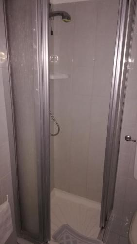 a shower with a glass door in a bathroom at Affittacamere Entreves in La Thuile