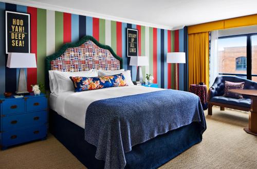 a bedroom with a large bed and a chair at Graduate by Hilton Annapolis in Annapolis