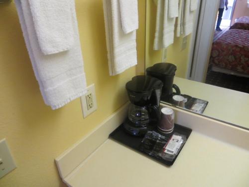a coffee maker on a counter in a hotel room at La Grange Executive Inn and Suites in La Grange