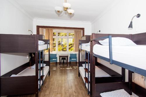 a room with three bunk beds and a table at Hostel Wratislavia in Wrocław